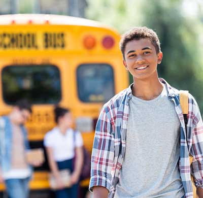 Happy Teen at school bus